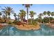 Community pool area with tropical landscaping and a shallow area marked as 3 feet at 202 Napoli Dr # 202, Davenport, FL 33897