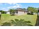Home exterior featuring a well-kept backyard, white fence, and lawn at 2024 Beardsley Dr, Apopka, FL 32703