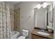 Bathroom featuring a shower-tub combo with tiled walls, a single-sink vanity, and classic fixtures at 2024 Beardsley Dr, Apopka, FL 32703
