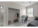 Well-lit bedroom featuring built-in closet storage, work space, and a comfortable bed for rest and productivity at 2024 Beardsley Dr, Apopka, FL 32703