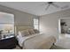 Bedroom featuring ceiling fan, neutral colors, a queen bed, and a view of the entry hall at 2024 Beardsley Dr, Apopka, FL 32703
