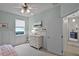 Relaxing bedroom featuring wainscoting, soft colors, natural light, and modern decor for a peaceful ambiance at 2024 Beardsley Dr, Apopka, FL 32703