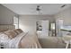 Bright bedroom featuring a ceiling fan, neutral color palette, and access to the living room and a private bathroom at 2024 Beardsley Dr, Apopka, FL 32703