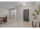 Inviting entryway featuring tiled floor, front door and a dining area with a dark wood table at 2024 Beardsley Dr, Apopka, FL 32703