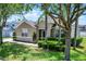 Well-maintained exterior of the home with lush greenery and manicured landscaping at 2024 Beardsley Dr, Apopka, FL 32703