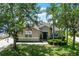 Charming one-story home with lush landscaping, mature trees, and a well-manicured lawn at 2024 Beardsley Dr, Apopka, FL 32703