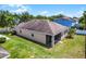 Exterior of a home with screen patio and well-maintained lawn and garden at 2024 Beardsley Dr, Apopka, FL 32703