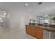 Open kitchen with stainless steel appliances, wood cabinets, and a granite countertop at 2024 Beardsley Dr, Apopka, FL 32703