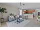 Modern living room with views to the kitchen featuring modern sofa and ceiling fan at 2024 Beardsley Dr, Apopka, FL 32703