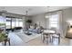 Bright and airy living room featuring a ceiling fan and sliding glass doors to the patio at 2024 Beardsley Dr, Apopka, FL 32703