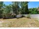 The backyard features a shelter, storage shed and a white fence around the perimeter of the yard at 2074 S Parkton Dr, Deltona, FL 32725