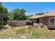 Backyard view with an above-ground pool, wooden deck, partial fence, and lush trees at 2074 S Parkton Dr, Deltona, FL 32725
