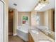 Well-lit bathroom featuring double vanity sinks, soaking tub, and a separate shower at 2074 S Parkton Dr, Deltona, FL 32725