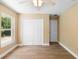 Bright bedroom with light wood floors, neutral walls, and a large closet for a cozy atmosphere at 2074 S Parkton Dr, Deltona, FL 32725