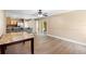 Open-concept dining room with wood floors, connecting to the kitchen, offering a spacious and modern layout at 2074 S Parkton Dr, Deltona, FL 32725