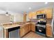Well-equipped kitchen features granite counters, stainless appliances, and wood cabinets, open to the dining area at 2074 S Parkton Dr, Deltona, FL 32725