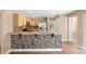 Stylish kitchen featuring wood cabinets, granite countertops, stainless steel appliances, and tile backsplash at 2074 S Parkton Dr, Deltona, FL 32725