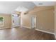 Well-lit living room boasts hard wood floors, vaulted ceilings and natural light at 2074 S Parkton Dr, Deltona, FL 32725