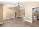 Open-concept living area with wood floors and decorative chandeliers, providing ample space at 2074 S Parkton Dr, Deltona, FL 32725