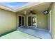 Covered patio with ceiling fan, TV, and sliding glass doors, perfect for outdoor entertaining at 2074 S Parkton Dr, Deltona, FL 32725
