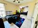 A bedroom with light tan walls, tile floors, and a black comforter featuring gaming-themed graphics at 2108 Shannon Lakes Blvd, Kissimmee, FL 34743