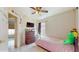 Cozy bedroom features a twin bed, neutral walls, and a window providing natural light and a glimpse of the outdoors at 2108 Shannon Lakes Blvd, Kissimmee, FL 34743