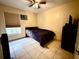 Simply decorated bedroom with tile floors, dark furnishings, and a window view at 2108 Shannon Lakes Blvd, Kissimmee, FL 34743