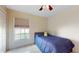 Cozy bedroom with a twin bed, window, and neutral color scheme at 2108 Shannon Lakes Blvd, Kissimmee, FL 34743