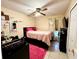 Comfortable bedroom featuring tile floors, a ceiling fan, and a cozy bed at 2108 Shannon Lakes Blvd, Kissimmee, FL 34743