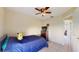 Comfortable bedroom with a ceiling fan, twin bed, and closet at 2108 Shannon Lakes Blvd, Kissimmee, FL 34743