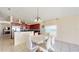 Open concept dining room with adjacent kitchen and modern white table set at 2108 Shannon Lakes Blvd, Kissimmee, FL 34743