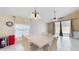 Bright dining room with modern lighting fixture, white table and chairs at 2108 Shannon Lakes Blvd, Kissimmee, FL 34743
