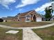 Cozy home with a well-maintained lawn, featuring a two-car garage at 2108 Shannon Lakes Blvd, Kissimmee, FL 34743