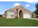Charming single-story home with a well-manicured lawn and attached garage at 2108 Shannon Lakes Blvd, Kissimmee, FL 34743