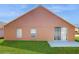 Charming exterior with a lush green lawn and sliding glass doors at 2108 Shannon Lakes Blvd, Kissimmee, FL 34743