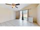 Bright living room with a sliding glass door, tiled floors, and neutral color scheme at 2108 Shannon Lakes Blvd, Kissimmee, FL 34743
