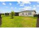 Spacious backyard features lush green grass, a black metal fence and a small area for outdoor seating at 2524 Datura Loop, St Cloud, FL 34772