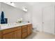 Bathroom featuring a double vanity, a large mirror, and neutral-toned tiled floors at 2524 Datura Loop, St Cloud, FL 34772
