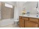 Well-lit bathroom featuring a tub and shower combination and a wooden vanity at 2524 Datura Loop, St Cloud, FL 34772