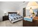 Comfortable bedroom with a queen-sized bed, stylish decor, and an en-suite bathroom at 2524 Datura Loop, St Cloud, FL 34772