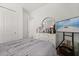 Relaxing bedroom with a round mirror, a TV, and a dresser with decorative items at 2524 Datura Loop, St Cloud, FL 34772