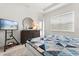 Comfortable bedroom with a queen-sized bed, stylish decor, and a large window with natural light at 2524 Datura Loop, St Cloud, FL 34772