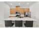 Beautiful kitchen island with modern appliances, wooden cabinetry and pendant lighting at 2524 Datura Loop, St Cloud, FL 34772