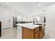 Bright open kitchen with a center island and an eat-in bar overlooks the dining and living area at 2524 Datura Loop, St Cloud, FL 34772