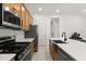 Modern kitchen features stainless steel appliances, wooden cabinetry, and a convenient layout at 2524 Datura Loop, St Cloud, FL 34772
