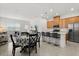 Open floor plan with a dining area, and a stylish kitchen with stainless steel appliances at 2524 Datura Loop, St Cloud, FL 34772
