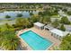 Community pool boasts lounge area and shade, perfect for relaxing or swimming in the sun at 2524 Datura Loop, St Cloud, FL 34772