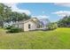 Well manicured backyard featuring screened in porch and luscious green grass at 2598 Ekana Dr, Oviedo, FL 32765