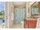 Cozy bathroom with decorative tile shower, granite counters and a direct exit to the outdoor pool at 2598 Ekana Dr, Oviedo, FL 32765