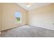 Neutral bedroom featuring carpet floors, a ceiling fan, and a window with a view of the lawn at 2598 Ekana Dr, Oviedo, FL 32765
